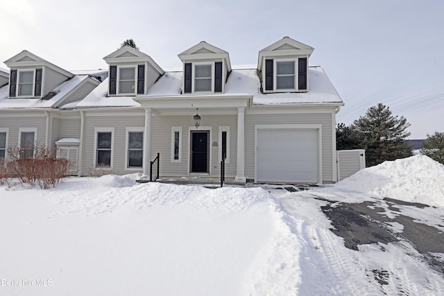 cape cod house featuring a garage