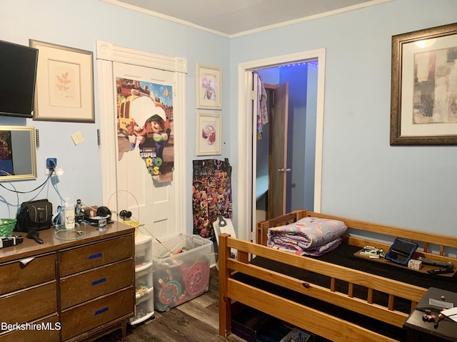 bedroom featuring ornamental molding and dark hardwood / wood-style flooring