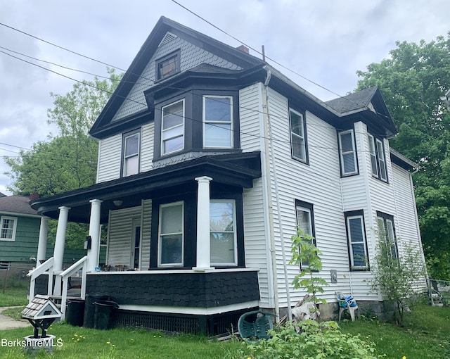 view of property exterior featuring covered porch