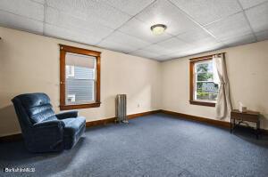 unfurnished room with a paneled ceiling and radiator