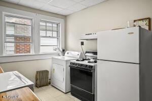 kitchen with white appliances, washer / clothes dryer, range hood, a paneled ceiling, and white cabinetry
