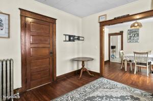 corridor with radiator and wood finished floors