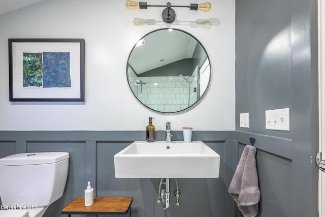 812 Canaan Southfield Rd, New Marlborough, MA 01259 - full bathroom with a decorative wall, lofted ceiling, toilet, a wainscoted wall, and a sink
