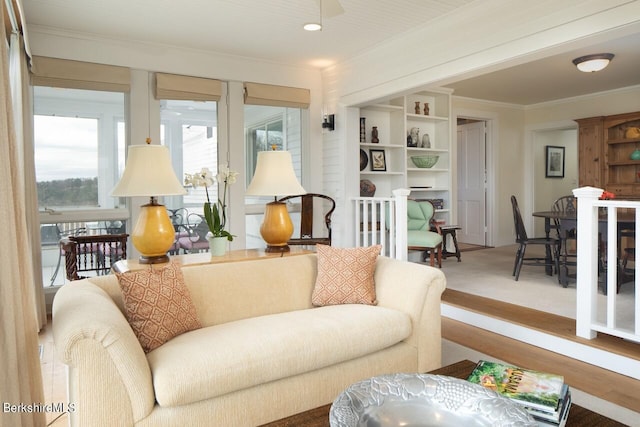 carpeted living room featuring ornamental molding