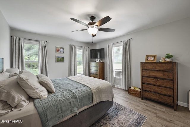 679 Middle Pownal Rd, Pownal, VT 05261 - bedroom with multiple windows, wood finished floors, ceiling fan, and cooling unit