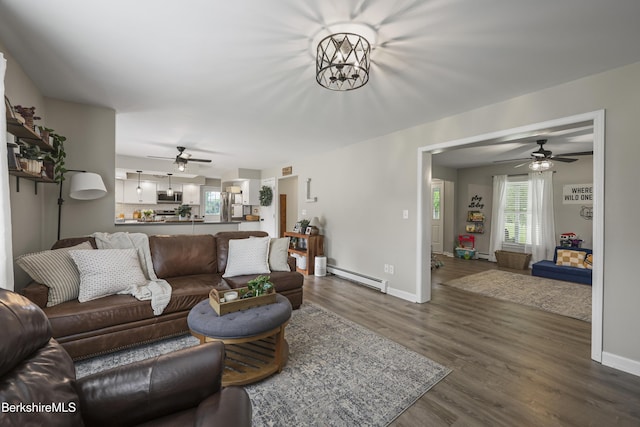 679 Middle Pownal Rd, Pownal, VT 05261 - living room with a baseboard radiator, a ceiling fan, and dark wood-style floors
