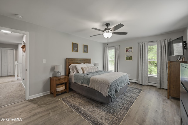 679 Middle Pownal Rd, Pownal, VT 05261 - bedroom with wood finished floors, baseboard heating, and ceiling fan