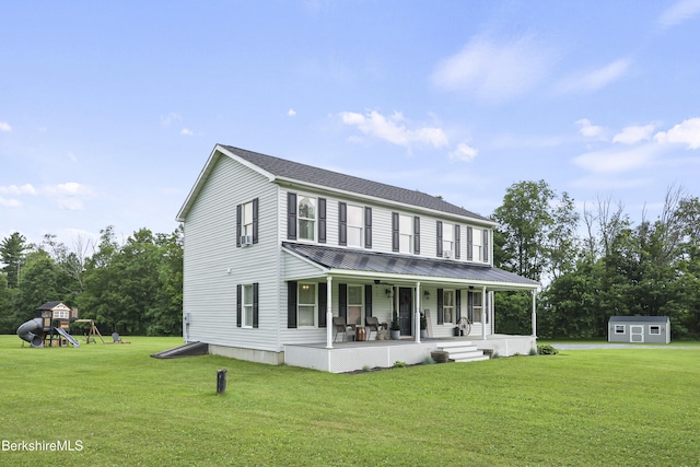 679 Middle Pownal Rd, Pownal, VT 05261 - view of front of property with covered porch, a front lawn, a storage unit, a metal roof, and a playground