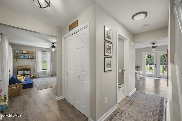 679 Middle Pownal Rd, Pownal, VT 05261 - hall with wood finished floors, a baseboard radiator, and french doors