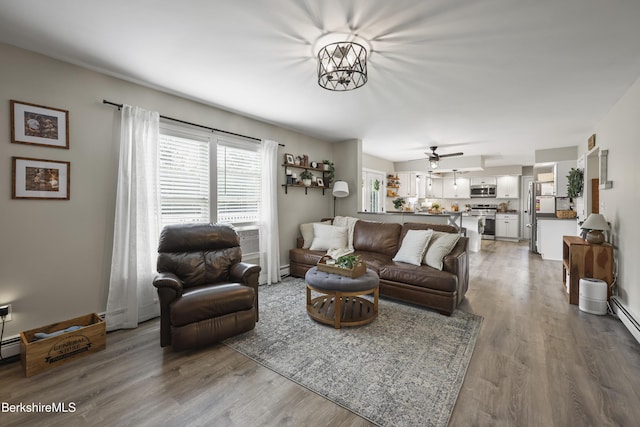 679 Middle Pownal Rd, Pownal, VT 05261 - living area with wood finished floors, ceiling fan, and a chandelier
