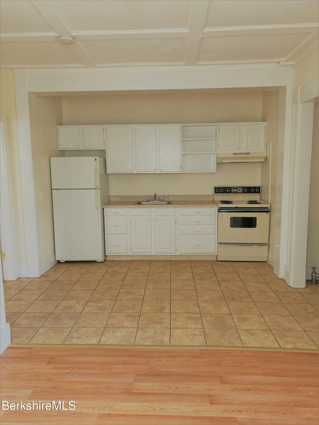 kitchen with light countertops, a sink, white appliances, and light tile patterned floors