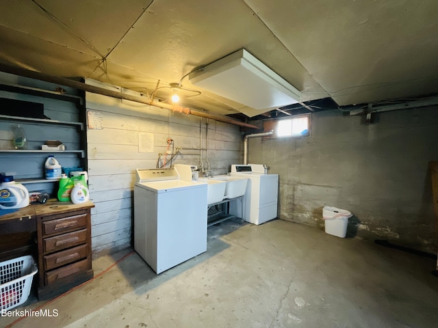 basement with a sink and washer and dryer