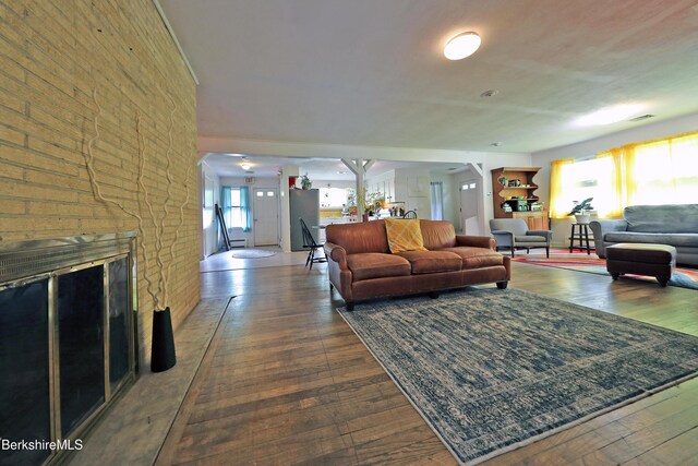 458 Monterey Rd, Great Barrington, MA 01230 - living area with dark wood-type flooring, a fireplace, and brick wall