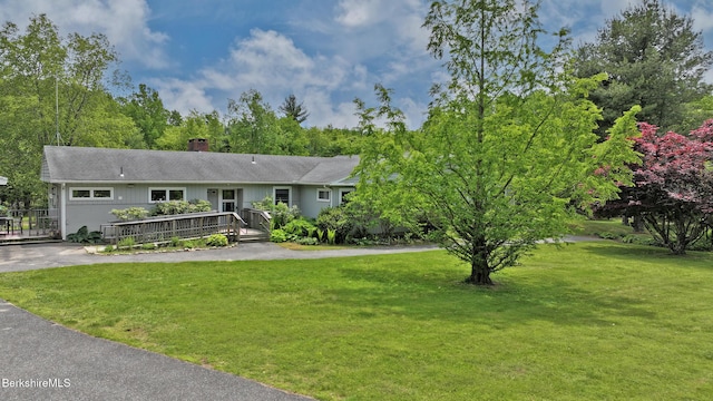 458 Monterey Rd, Great Barrington, MA 01230 - single story home featuring a front lawn, a chimney, a deck, and roof with shingles