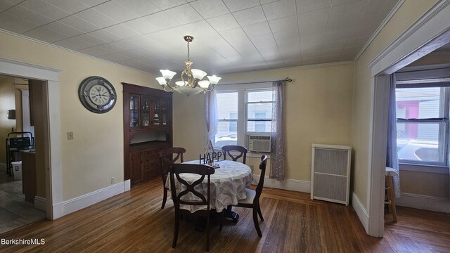 79 Marsden St, Springfield, MA 01109 - dining area with crown molding, a chandelier, wood finished floors, and baseboards