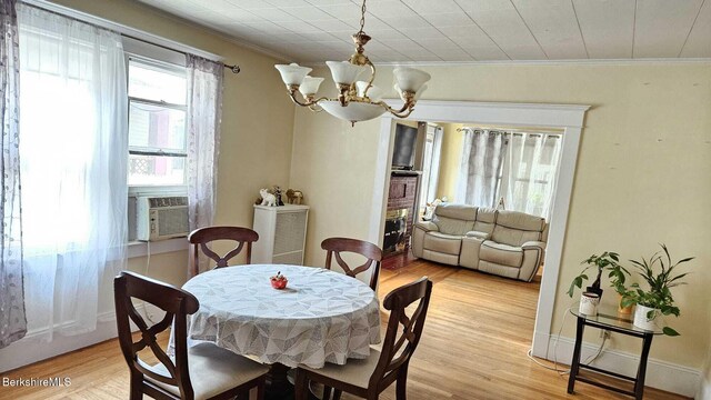 79 Marsden St, Springfield, MA 01109 - living room featuring a chandelier, ornamental molding, plenty of natural light, wood finished floors, and a brick fireplace