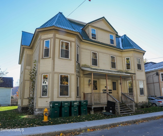 victorian-style house featuring covered porch