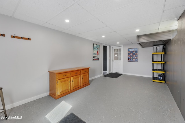 interior space featuring baseboards, recessed lighting, and a paneled ceiling