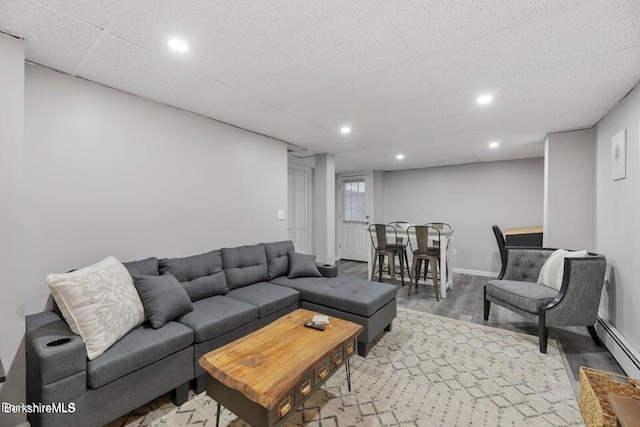 living room with baseboards, a baseboard radiator, recessed lighting, and wood finished floors