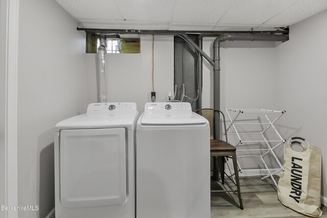 laundry area featuring laundry area, independent washer and dryer, and wood finished floors