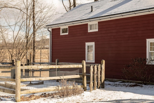 view of side of home featuring fence