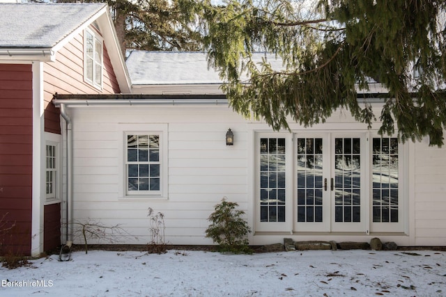 view of snowy exterior featuring french doors