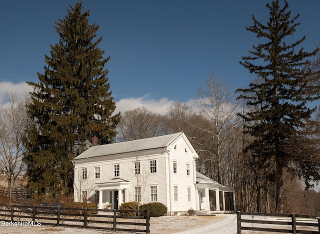 view of front facade featuring a fenced front yard and a chimney