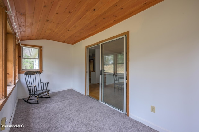 unfurnished room featuring carpet floors, baseboards, wood ceiling, and lofted ceiling