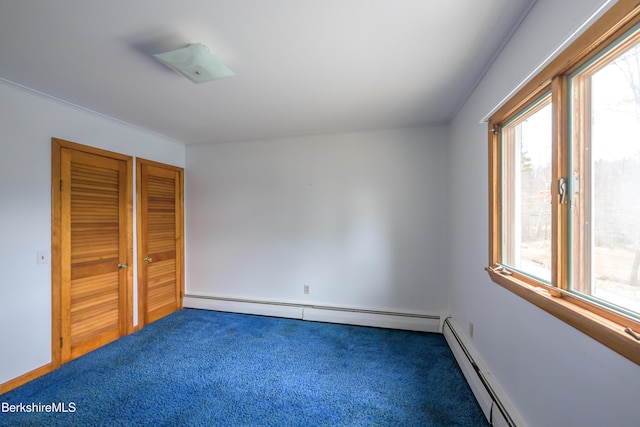 unfurnished bedroom featuring a closet, carpet floors, baseboards, and a baseboard heating unit