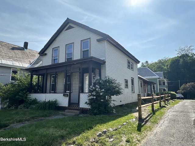 287 Houghton St, North Adams, MA 01247 - view of front of house featuring covered porch and a front lawn