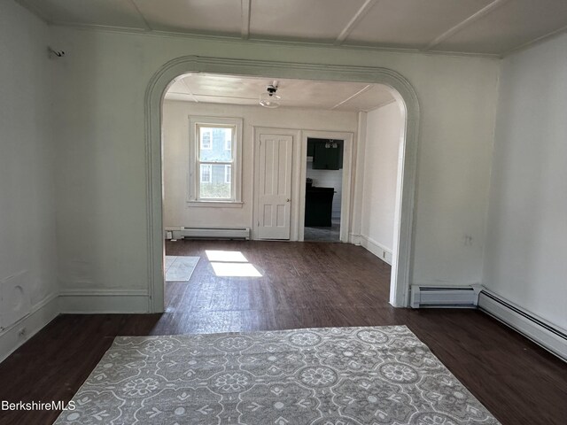 287 Houghton St, North Adams, MA 01247 - unfurnished dining area with arched walkways, a baseboard heating unit, wood finished floors, and baseboards