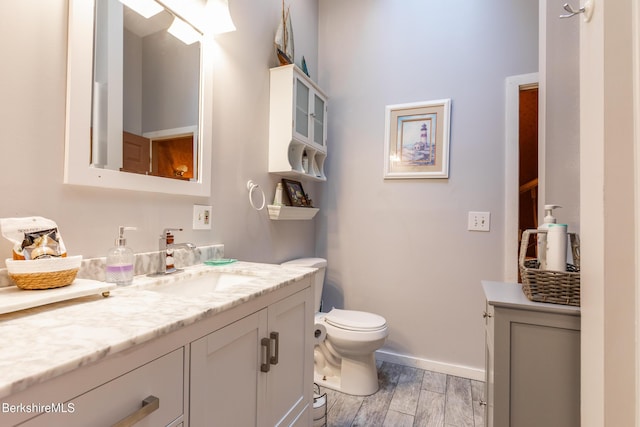 144 Brombach St, Pittsfield, MA 01201 - half bath with vanity, wood finished floors, toilet, and baseboards