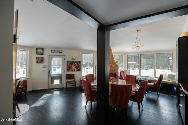 dining space featuring dark wood-style floors and baseboards