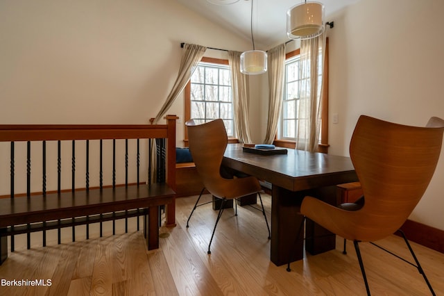 dining area with lofted ceiling and wood finished floors