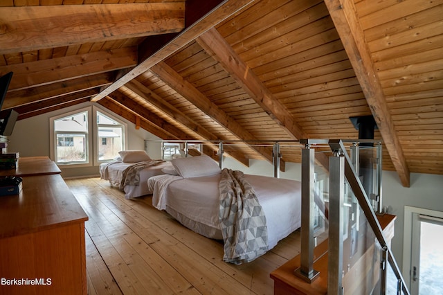 unfurnished bedroom with lofted ceiling with beams, hardwood / wood-style floors, and wood ceiling