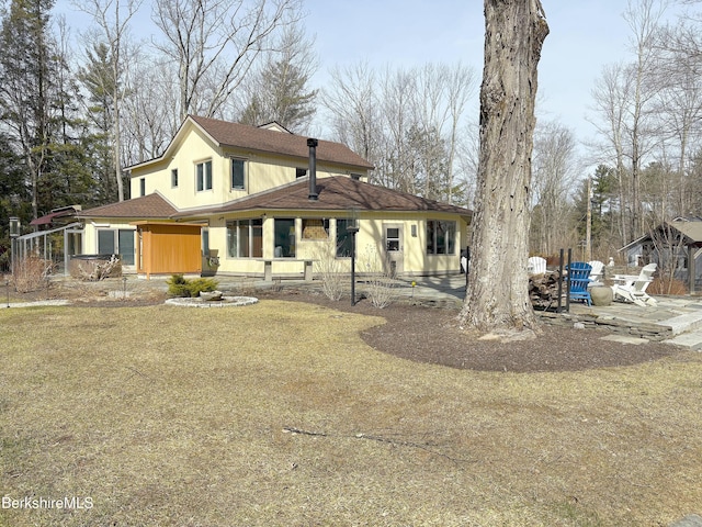 rear view of property featuring roof with shingles