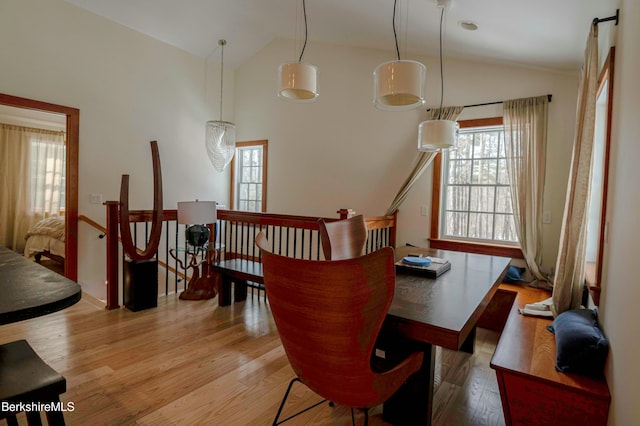 dining space featuring lofted ceiling and wood finished floors