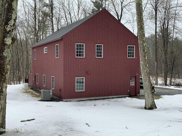 snow covered property featuring central AC