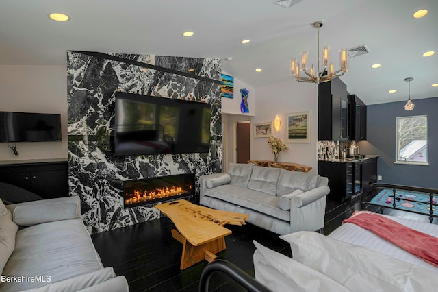 living room featuring lofted ceiling, a fireplace, visible vents, and recessed lighting