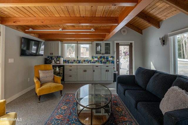 living room featuring beverage cooler, wooden ceiling, lofted ceiling with beams, and baseboards