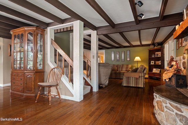 interior space with beam ceiling and dark hardwood / wood-style floors