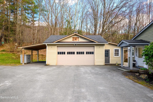 exterior space featuring a carport, a porch, and a garage