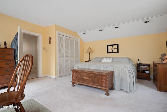 carpeted bedroom featuring vaulted ceiling and a closet