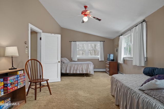 carpeted bedroom featuring ceiling fan, a baseboard radiator, and vaulted ceiling