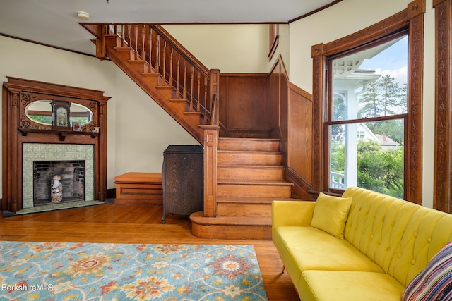 163 Cole Ave, Williamstown, MA 01267 - living area with stairway, wood finished floors, a tile fireplace, and ornamental molding