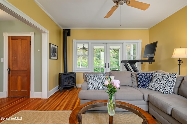 163 Cole Ave, Williamstown, MA 01267 - living room featuring french doors, wood finished floors, a wood stove, ornamental molding, and ceiling fan