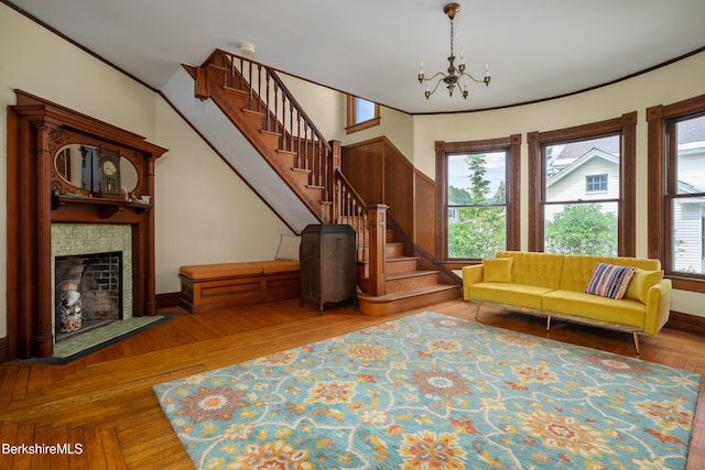 163 Cole Ave, Williamstown, MA 01267 - living area with stairs, a chandelier, a tiled fireplace, and wood finished floors