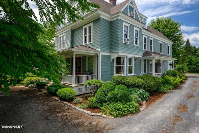 163 Cole Ave, Williamstown, MA 01267 - view of side of property with a porch, a chimney, roof with shingles, and cooling unit