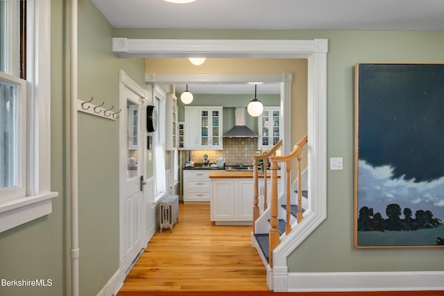 163 Cole Ave, Williamstown, MA 01267 - hall with radiator, light wood-style floors, and stairway
