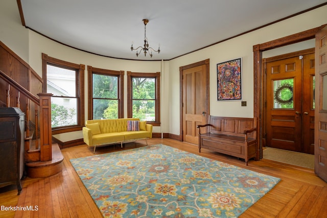 163 Cole Ave, Williamstown, MA 01267 - sitting room with plenty of natural light, a chandelier, stairs, wood-type flooring, and crown molding